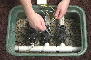 a Brampton irrigation contractor is inspecting the valve box