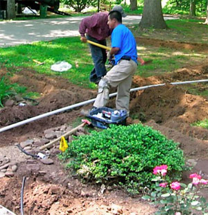 two of our Brampton contractors are placing the new pipes in the ground