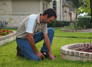 a professional contractor is replacing a broken sprinkler head